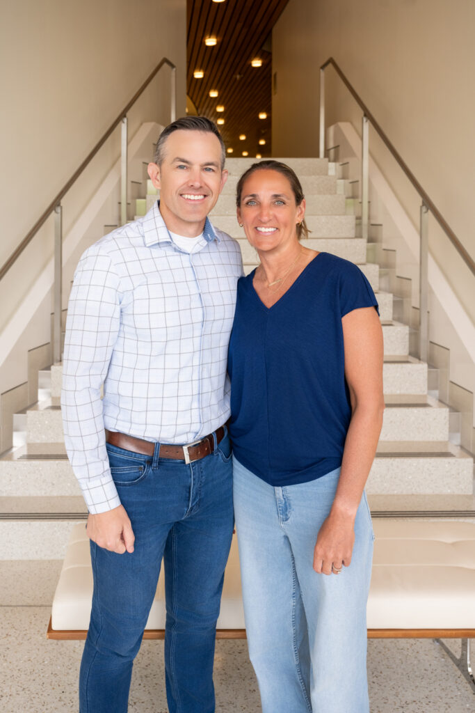 Dr Tanner And Dr Sarah Standing At The Bottom Of A Staircase